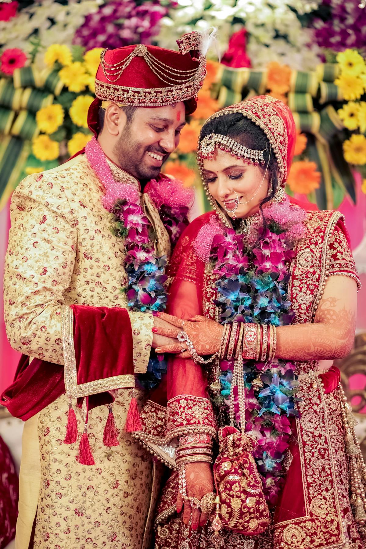 Indian couple at mandap with vibrant varmala garlands — Panigrahana Weddings Kerala