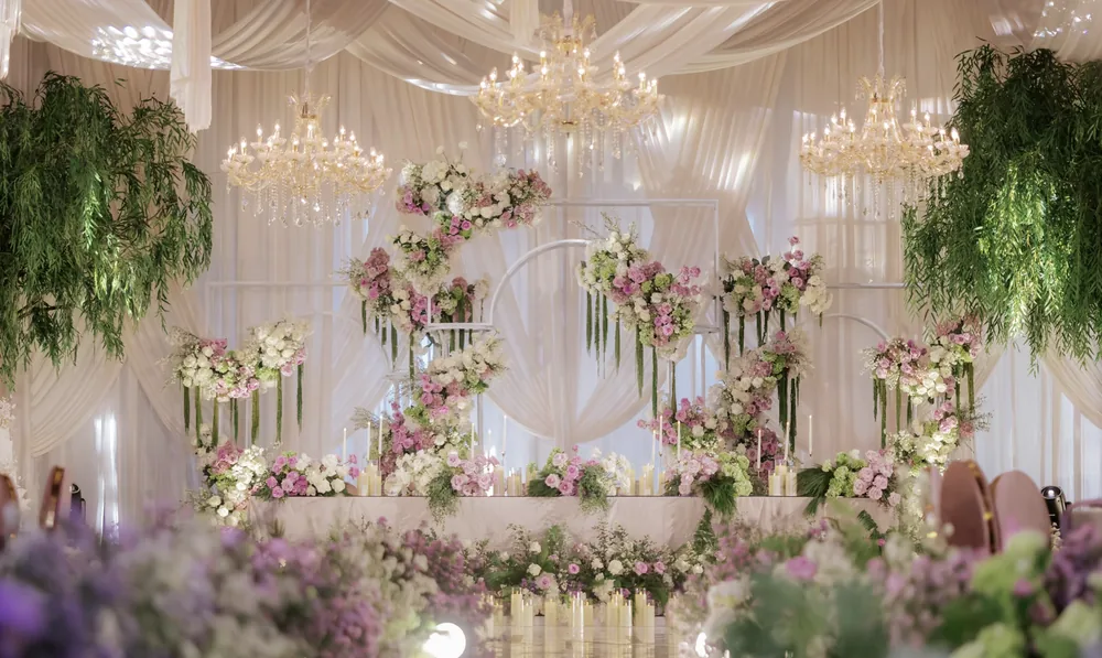 Pastel floral stage beneath chandeliers at Hilton Bali — Panigrahana decor portfolio