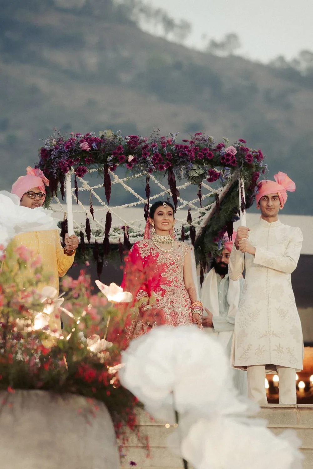 Bridal entrance beneath a burgundy floral chadar — Panigrahana decor portfolio