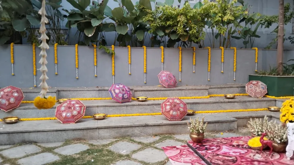 Courtyard haldi setting with floral baskets at Prangana